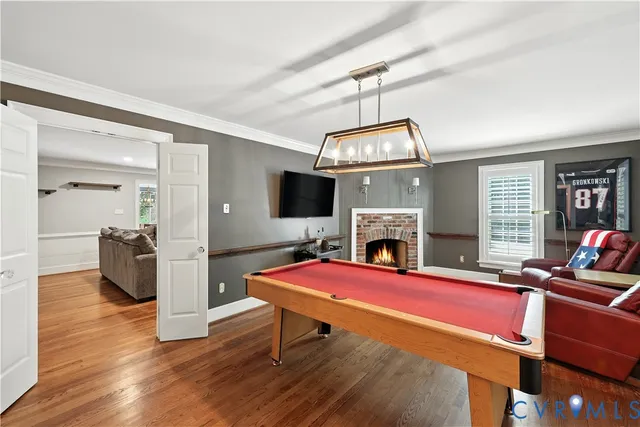 a living room with furniture flat screen tv and a fireplace