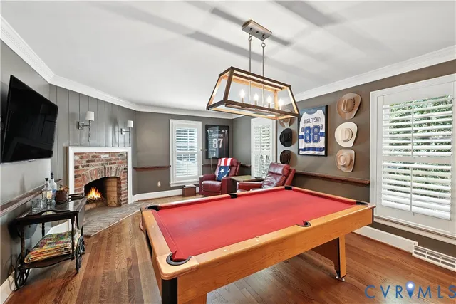 a view of a livingroom with furniture a flat screen tv and wooden floor