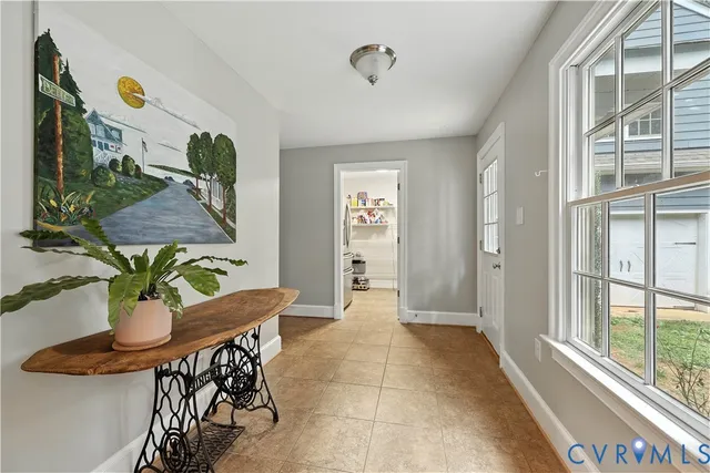 a view of a dining room with furniture and a potted plant
