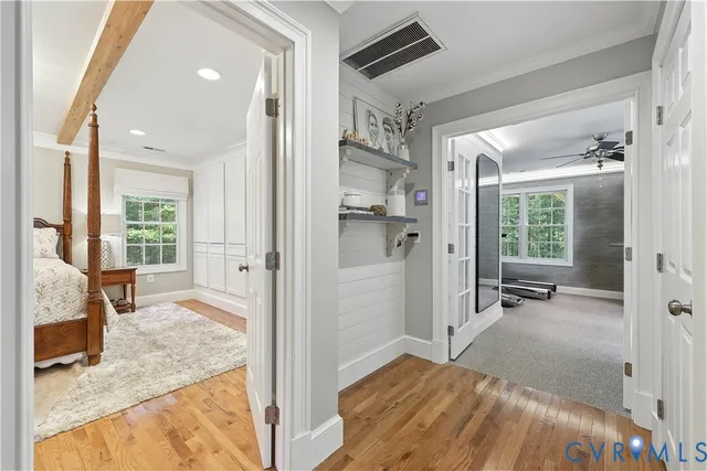 a view of a bedroom with a bed and wooden floor