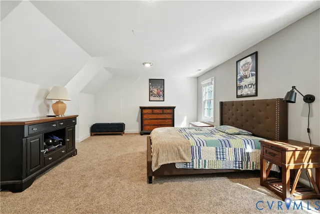 a bedroom with a bed and a tv