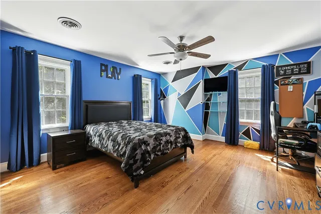 a bedroom with a bed dresser and a window