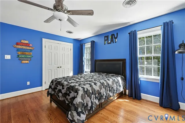 a bedroom with a bed dresser and a window