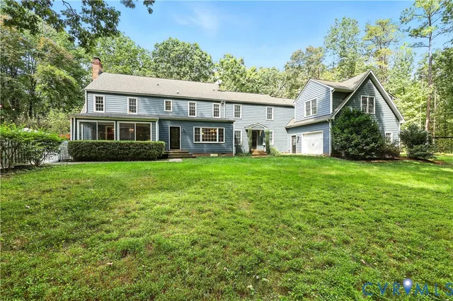 a view of a house with a yard and potted plants