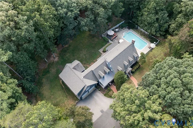 an aerial view of a house with a yard and garden