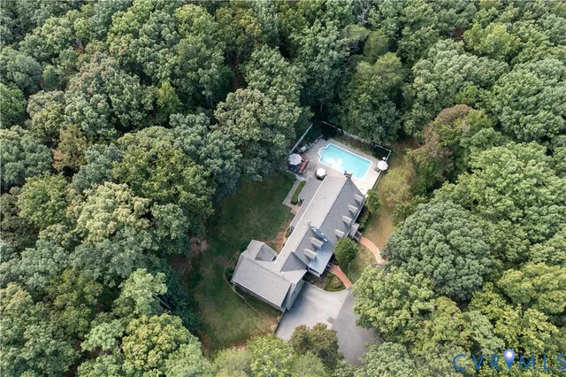 an aerial view of a house with a yard and garden