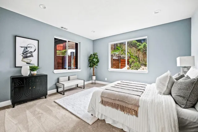 a bedroom with a large bed and a window