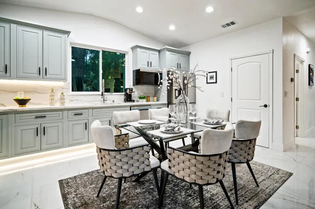 a dining room with furniture a rug and a chandelier
