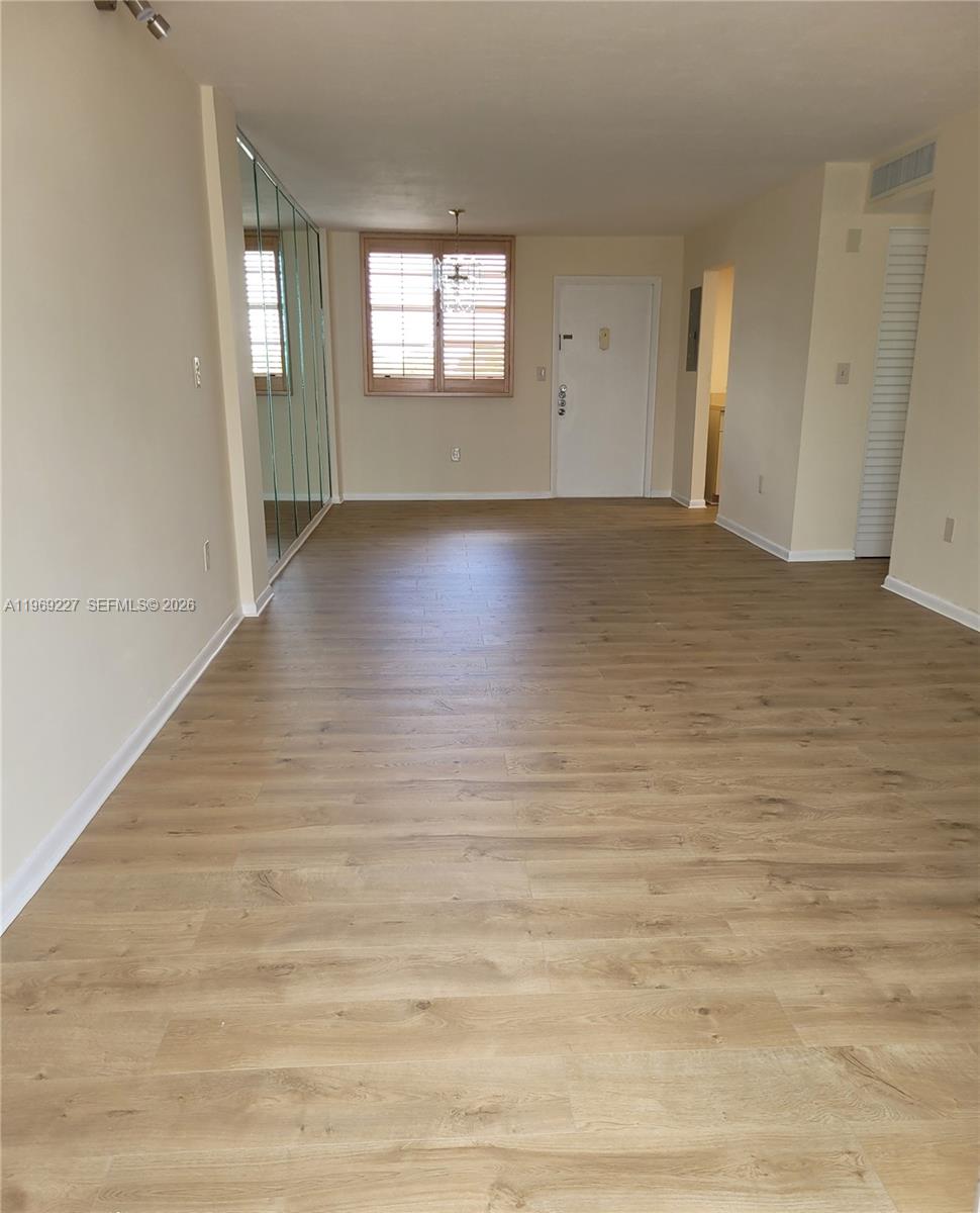 14140 Southwest 84th Street, Unit 301H Miami, FL 33183 - Photo 15 of 39 an empty room with wooden floor and windows