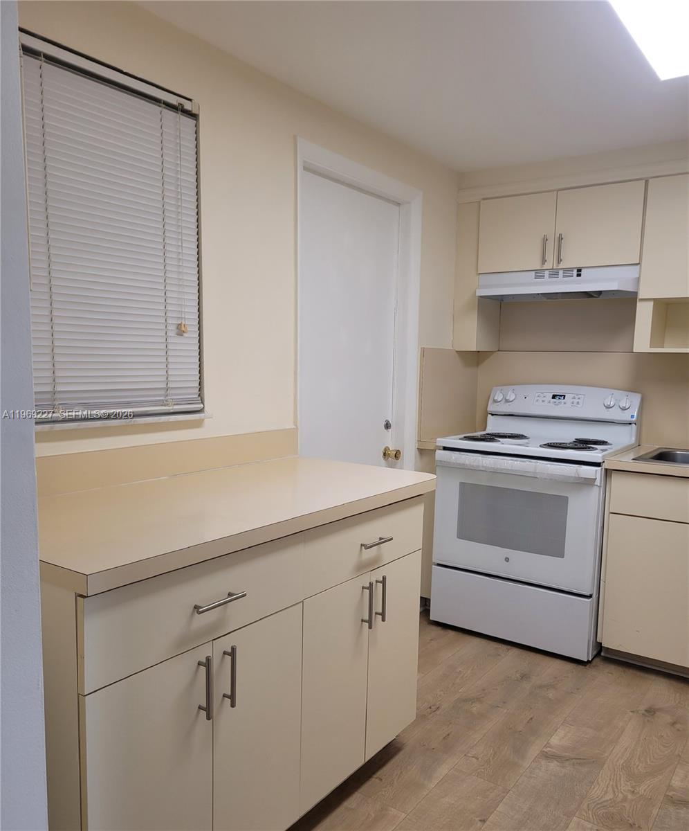 14140 Southwest 84th Street, Unit 301H Miami, FL 33183 - Photo 20 of 39 a kitchen with white cabinets and white appliances