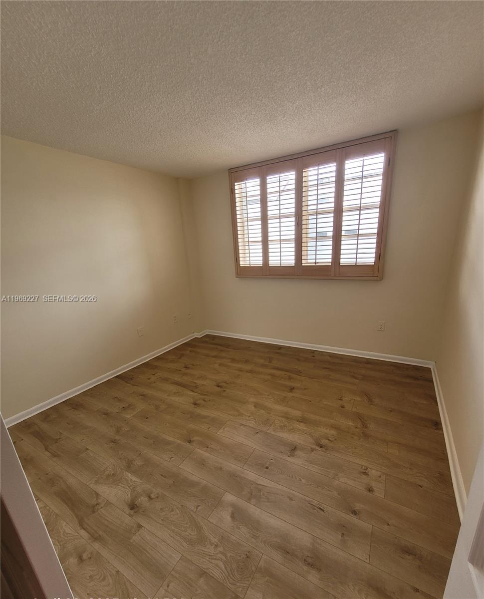 14140 Southwest 84th Street, Unit 301H Miami, FL 33183 - Photo 23 of 39 wooden floor in an empty room