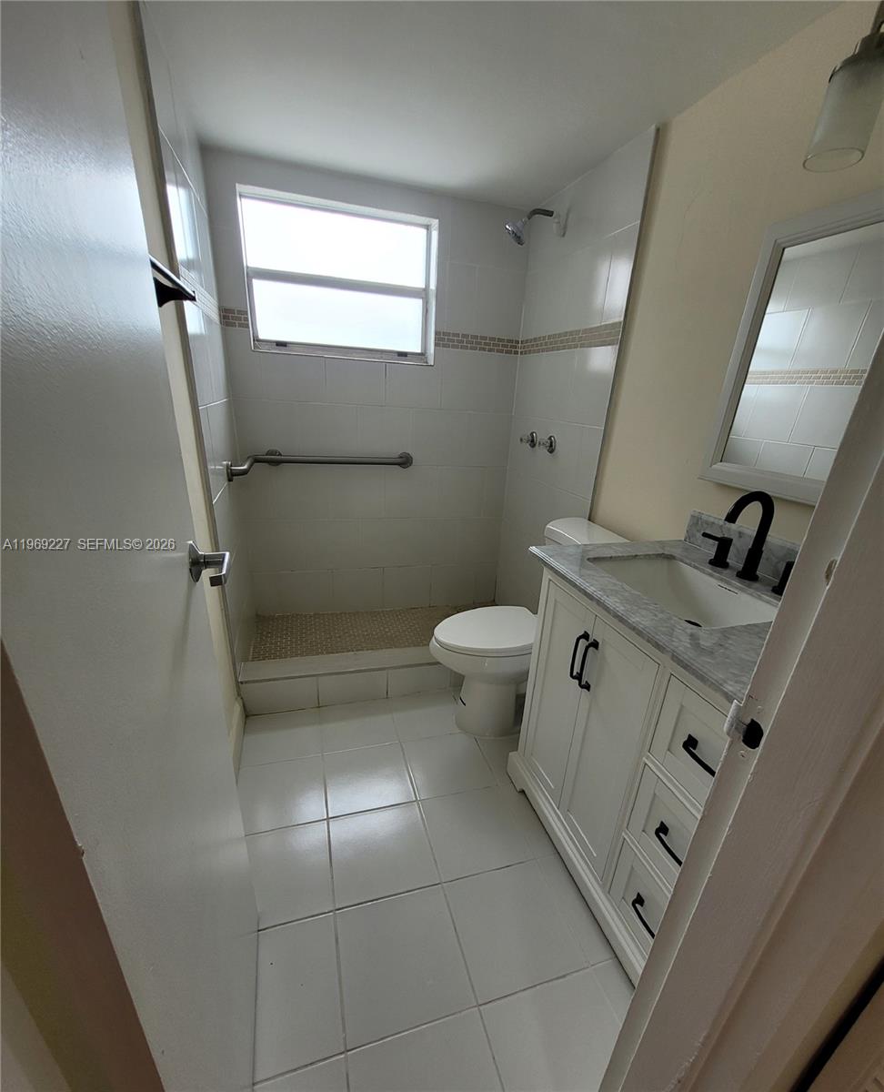 14140 Southwest 84th Street, Unit 301H Miami, FL 33183 - Photo 24 of 39 a bathroom with a sink a toilet and shower