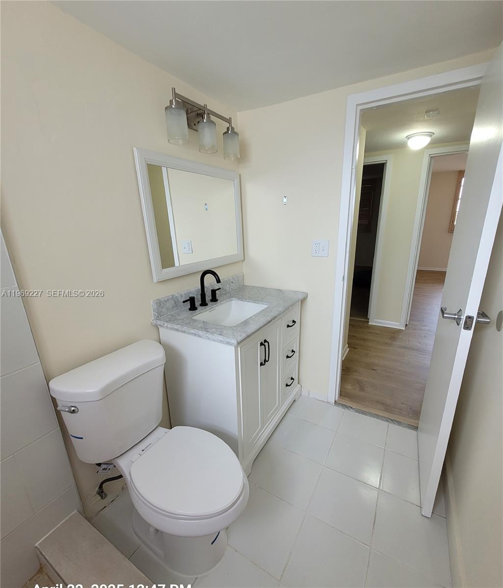 14140 Southwest 84th Street, Unit 301H Miami, FL 33183 - Photo 25 of 39 a bathroom with a toilet sink and mirror