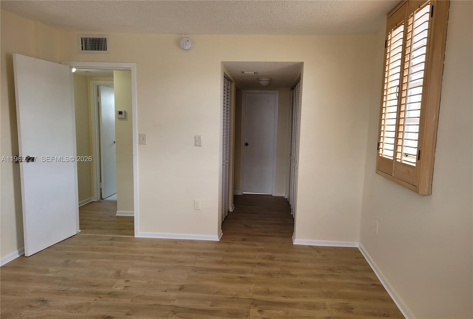 14140 Southwest 84th Street, Unit 301H Miami, FL 33183 - Photo 28 of 39 a view of entryway with window and wooden floor