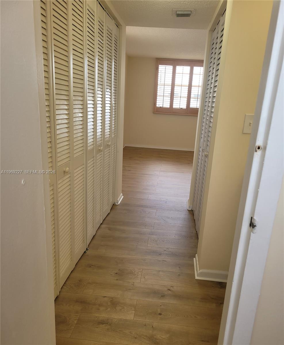 14140 Southwest 84th Street, Unit 301H Miami, FL 33183 - Photo 29 of 39 a view of hallway with windows