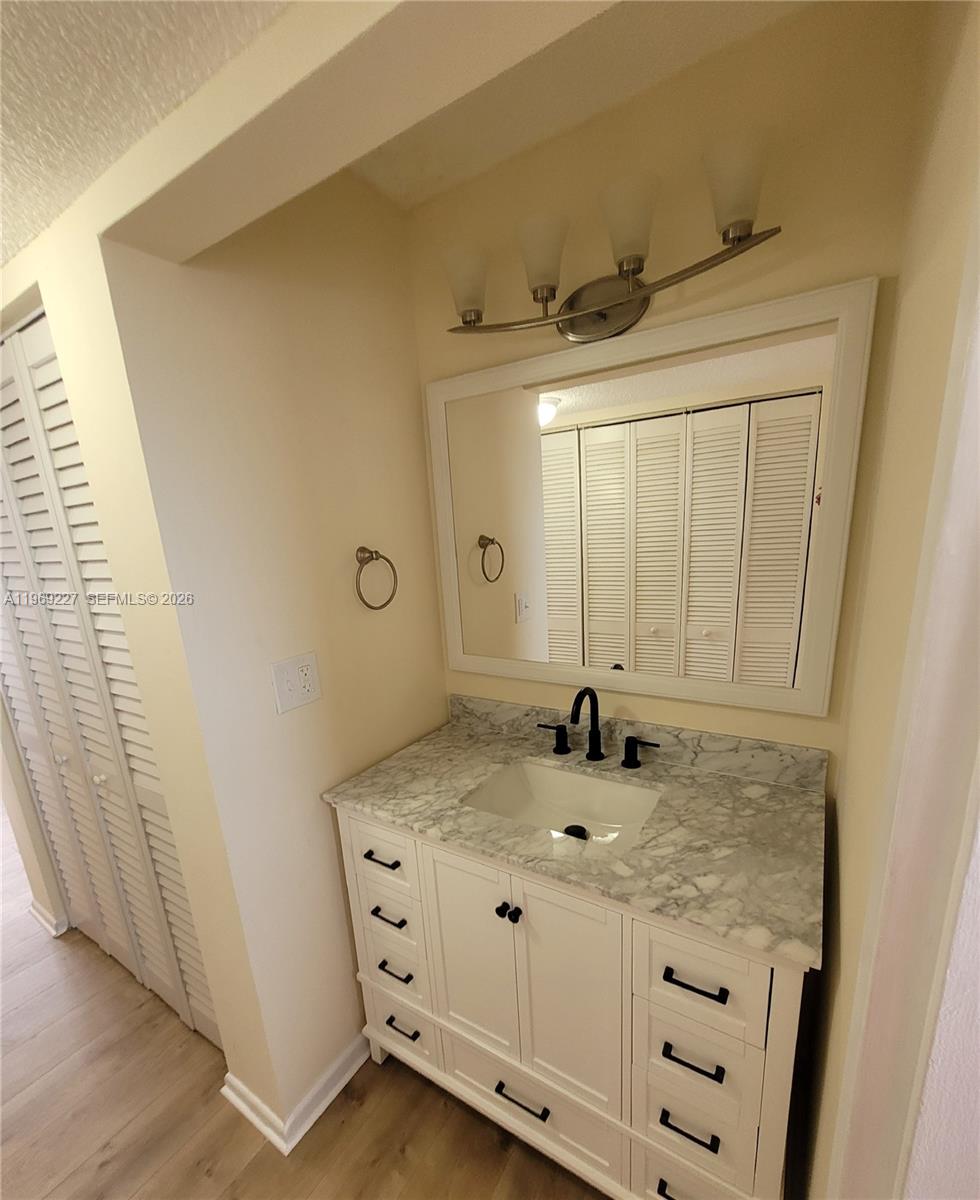 14140 Southwest 84th Street, Unit 301H Miami, FL 33183 - Photo 32 of 39 a bathroom with a sink and a mirror