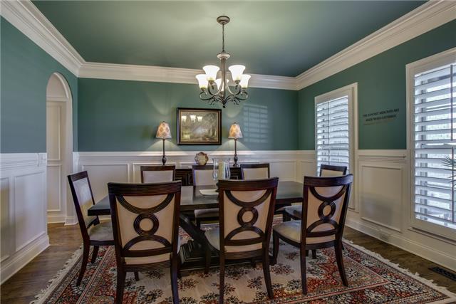 2063 Autumn Ridge Way Spring Hill, TN 37174 - Photo 3 of 20 The formal dining room is elegantly appointed with hardwood floors, lovely lighting, plantation shutters, wainscoting and crown molding.