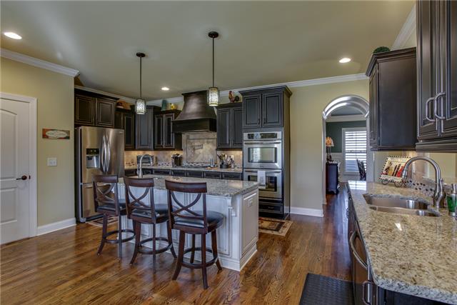 2063 Autumn Ridge Way Spring Hill, TN 37174 - Photo 7 of 20 This kitchen will awaken the cook in anyone - features include a gas cooktop, potfiller, granite counter tops, stainless appliances, recessed and pendant lighting, center island, 2 sinks, pantry and a large breakfast area with vaulted ceiling.