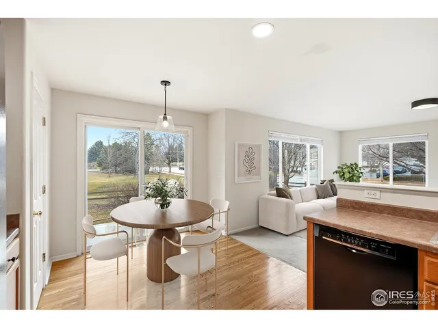 a kitchen with granite countertop a stove and a wooden floor