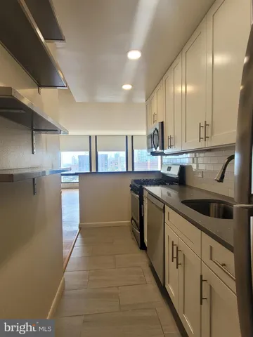 a kitchen with stainless steel appliances granite countertop a sink and cabinets