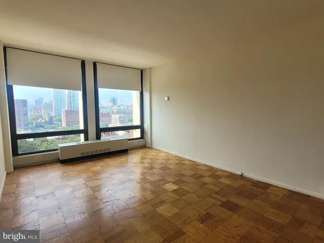 an empty room with large windows