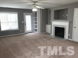 a view of livingroom with fan fireplace and window
