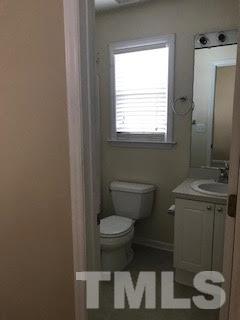 2444 Pumpkin Ridge Way Raleigh, NC 27604 - Photo 4 of 15 a bathroom with a toilet a sink and a window