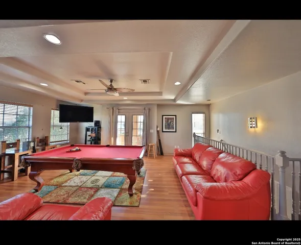 a living room with furniture a flat screen tv and a large window