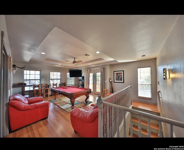 a living room with furniture a flat screen tv and a table