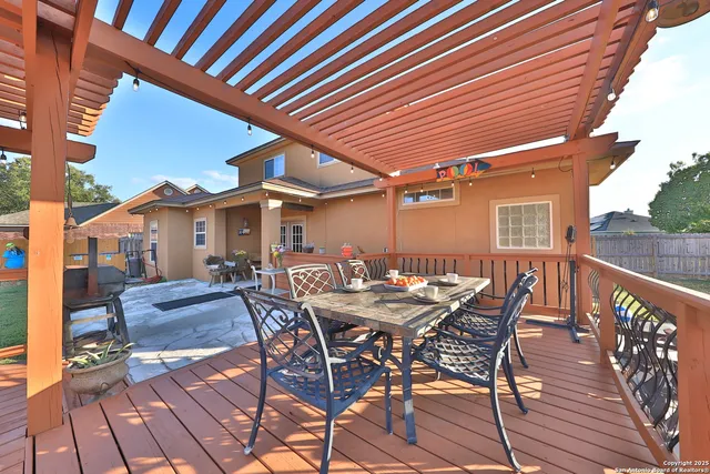 a patio with wooden floors and outdoor seating