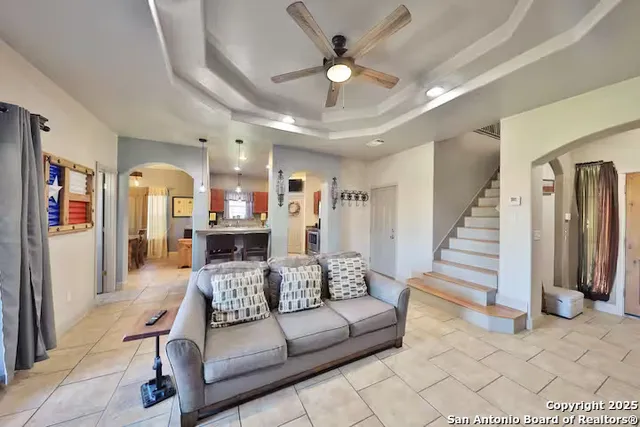 a living room with furniture ceiling fan and a rug