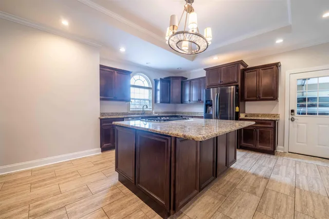 a kitchen with stainless steel appliances granite countertop a sink stove and refrigerator