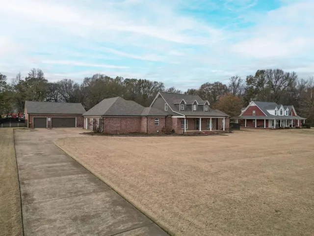 a view of a house with a yard and sitting area