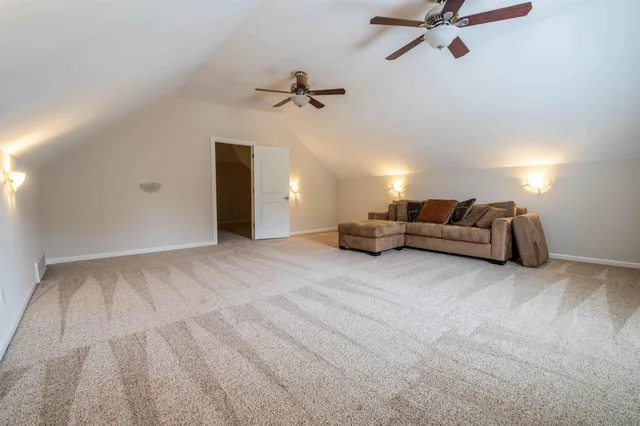 a view of a livingroom with furniture and a ceiling fan