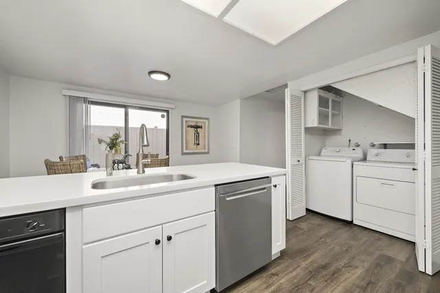 a kitchen with a sink cabinets appliances and cabinets