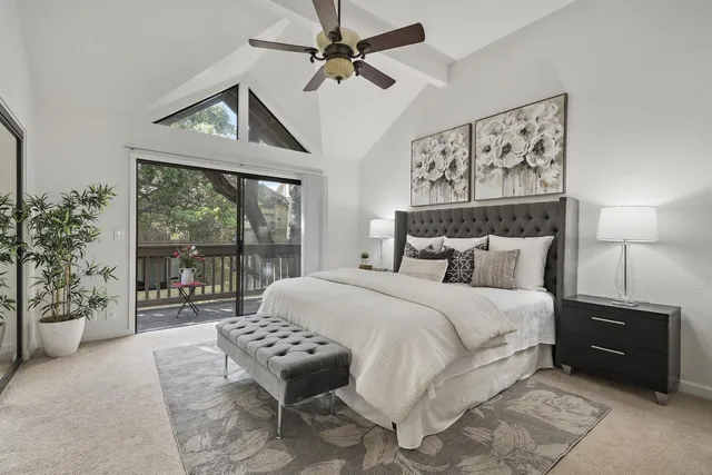 a bedroom with a large bed and a large window