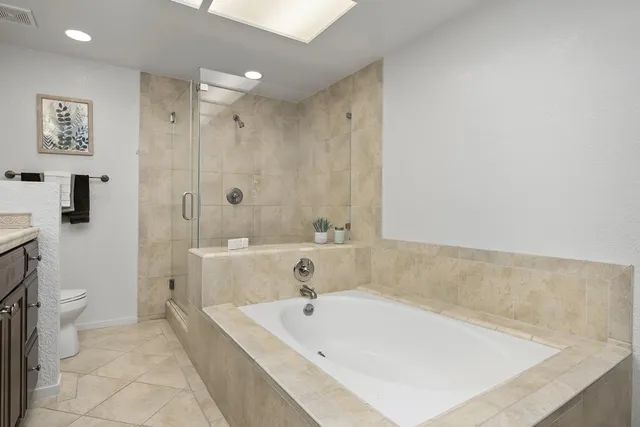 a bath tub sitting next to a white toilet