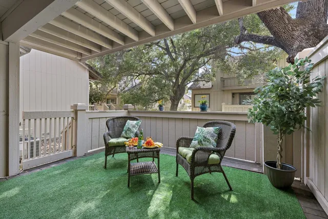 a backyard of a house with table and chairs