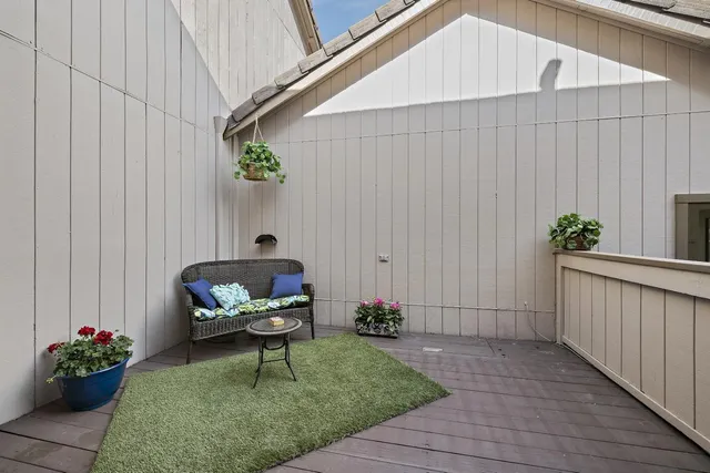 a backyard of a house with table and chairs