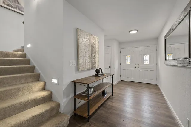 a view of a livingroom with furniture and stairs