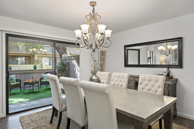 a view of a dining room with furniture wooden floor and a chandelier