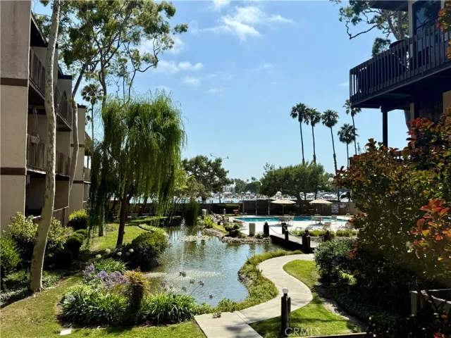 a swimming pool with outdoor seating and garden