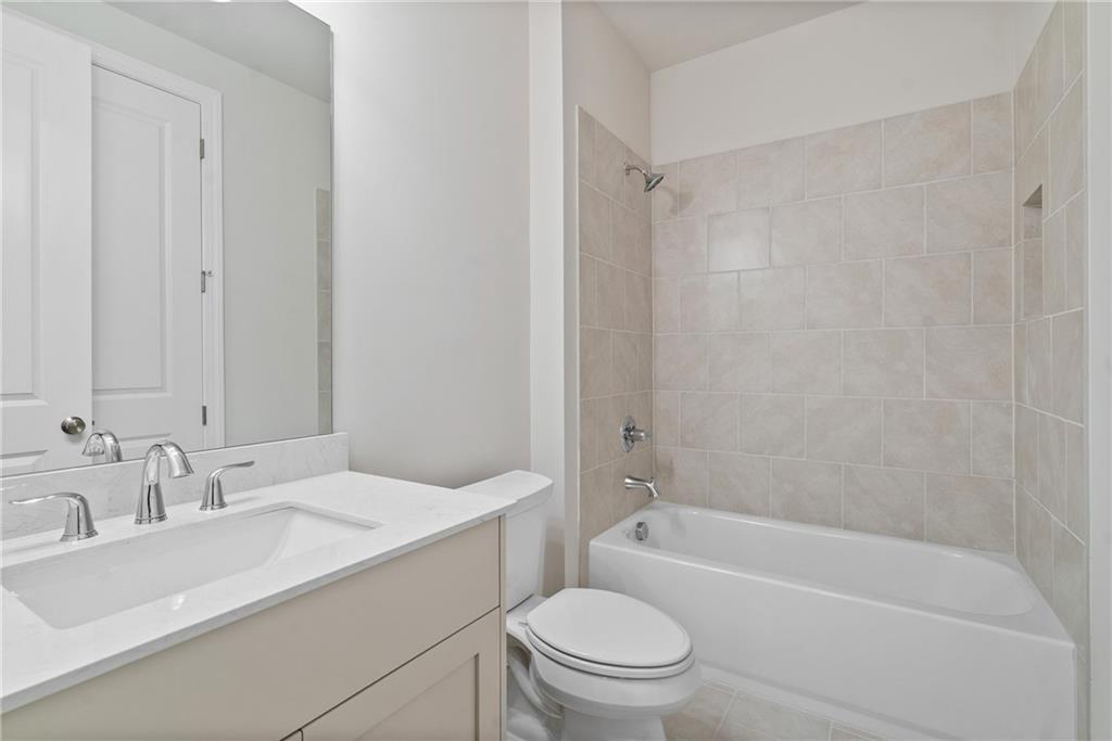 579 Pearl Street Cumming, GA 30040 - Photo 13 of 30 a bathroom with a sink toilet vanity and shower
