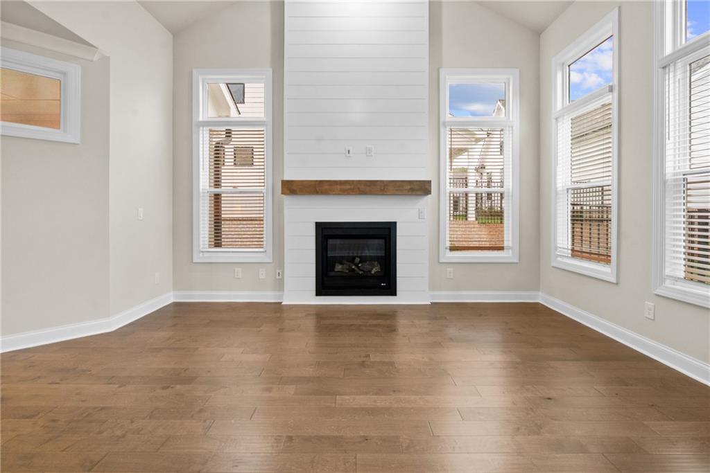 579 Pearl Street Cumming, GA 30040 - Photo 3 of 30 an empty room with windows and fireplace