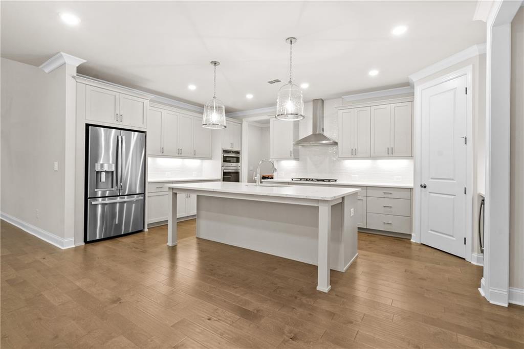 579 Pearl Street Cumming, GA 30040 - Photo 10 of 30 a kitchen with a refrigerator and a sink
