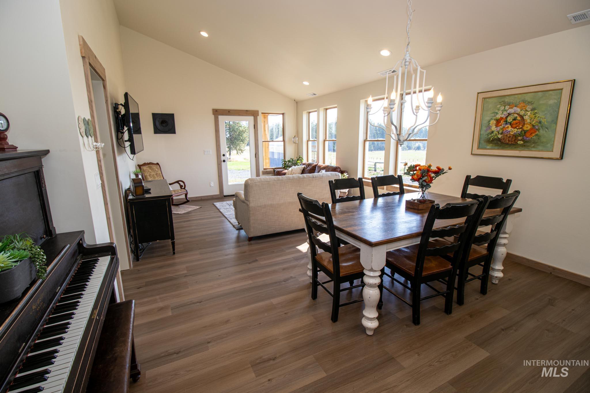 263 Glory Lane Orofino, ID 83544 - Photo 10 of 48 Dining room with lofted ceiling, wood finished floors, and a chandelier