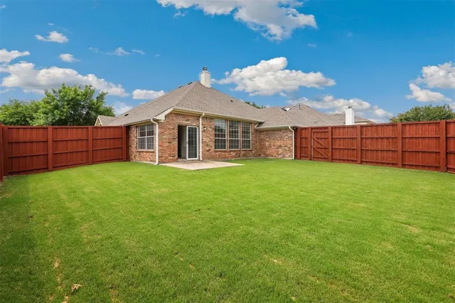 a view of a house with a yard and sitting area