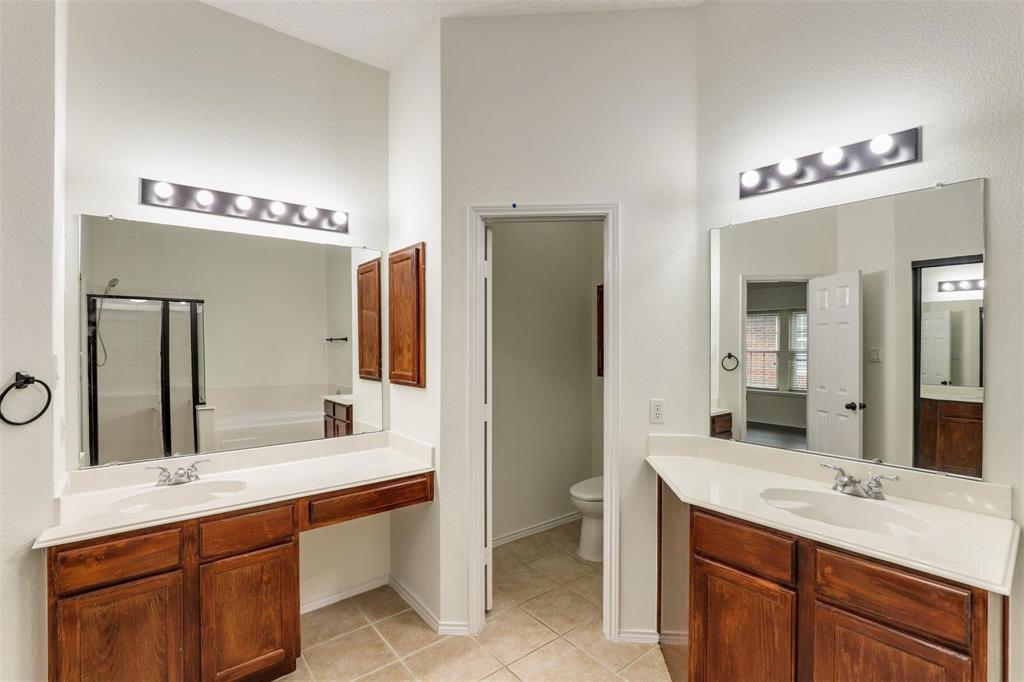 9914 Golden Rod Drive Frisco, TX 75035 - Photo 16 of 18 a bathroom with a double vanity sink and a mirror