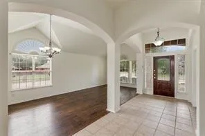 a view of a livingroom with a chandelier fan and fire place