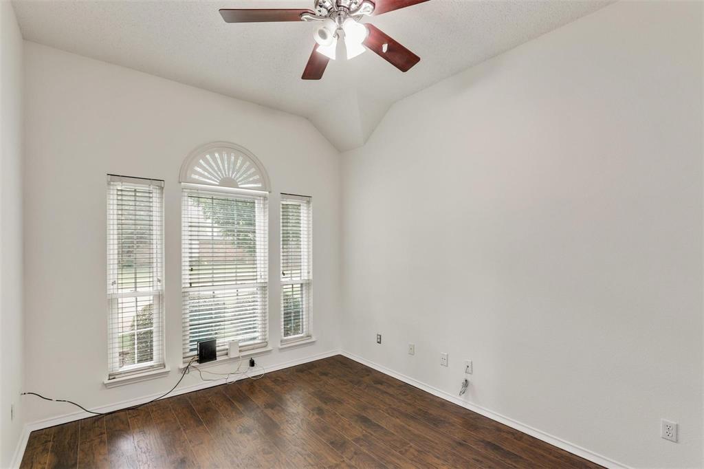 9914 Golden Rod Drive Frisco, TX 75035 - Photo 6 of 18 an empty room with wooden floor chandelier and windows